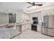 Bright kitchen features granite counters, stainless appliances, mosaic backsplash, and stone accent wall at 10296 Palmgren, Spring Hill, FL 34608