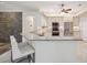 Bright kitchen features granite counters, stainless appliances, mosaic backsplash, and stone accent wall at 10296 Palmgren, Spring Hill, FL 34608