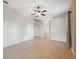 Spacious living room with neutral colors, a ceiling fan, and tile flooring throughout at 10296 Palmgren, Spring Hill, FL 34608