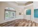 Bright living room with hardwood floors and large window showcasing the backyard at 10296 Palmgren, Spring Hill, FL 34608