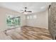 Spacious living room features wood floors, stone accent wall, and view of outdoor patio at 10296 Palmgren, Spring Hill, FL 34608