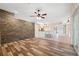 Spacious living room features wood floors, stone accent wall, and open floor plan at 10296 Palmgren, Spring Hill, FL 34608