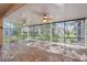 This screened patio features a unique stone floor, multiple ceiling fans, and an excellent view of the backyard at 10296 Palmgren, Spring Hill, FL 34608