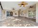 Large screened-in patio with stone flooring, ceiling fans, and backyard access at 10296 Palmgren, Spring Hill, FL 34608