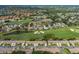 Aerial view of the community with golf course, multiple ponds and single-Gathering homes at 1105 Flora Vista St, New Port Richey, FL 34655