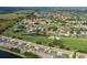 Beautiful aerial view of a golf course community with lush green fairways, multiple ponds, and well-maintained homes with orange roofs at 1105 Flora Vista St, New Port Richey, FL 34655