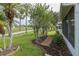 Well-manicured lawn and landscaping line this lovely home's exterior, alongside a brick path to the lanai at 1105 Flora Vista St, New Port Richey, FL 34655
