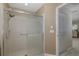 Bathroom featuring tiled shower with glass door and modern fixtures at 1105 Flora Vista St, New Port Richey, FL 34655