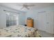 Comfortable bedroom with light blue walls, a ceiling fan, and closet at 1105 Flora Vista St, New Port Richey, FL 34655