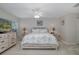 Bright bedroom featuring carpet floors, a ceiling fan, and views through the large window at 1105 Flora Vista St, New Port Richey, FL 34655