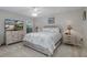 Bright bedroom featuring neutral tones, carpet floors, and views through the large window at 1105 Flora Vista St, New Port Richey, FL 34655