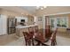 Dining area showcasing a dining table, chairs, and adjacent kitchen with modern appliances at 1105 Flora Vista St, New Port Richey, FL 34655