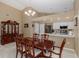 Dining area featuring a large table, stylish lighting, and open access to the kitchen at 1105 Flora Vista St, New Port Richey, FL 34655