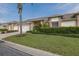 Charming home featuring a well-manicured lawn, beautiful landscaping, and an attached two-car garage at 1105 Flora Vista St, New Port Richey, FL 34655