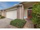 A one-story home featuring a double-car garage, a brick facade, and a brick paver walkway leading to the front door at 1105 Flora Vista St, New Port Richey, FL 34655