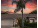Charming one story home featuring a double door entrance, a brick facade and a palm tree at 1105 Flora Vista St, New Port Richey, FL 34655