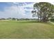 Scenic view of the golf course surrounded by trees, green grass and community homes at 1105 Flora Vista St, New Port Richey, FL 34655
