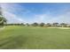 Scenic view of a lush golf course, featuring a tranquil pond and well-maintained fairways at 1105 Flora Vista St, New Port Richey, FL 34655