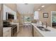 Bright kitchen with stainless appliances, white cabinetry, and breakfast nook with natural light at 1105 Flora Vista St, New Port Richey, FL 34655