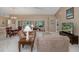 Spacious living room featuring high ceilings, carpeted floors, tan walls, and an open floor plan at 1105 Flora Vista St, New Port Richey, FL 34655