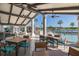 Inviting outdoor patio featuring stylish tables and chairs, perfect for dining and entertaining, overlooking the serene lake at 1105 Flora Vista St, New Port Richey, FL 34655