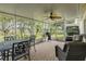 Enjoy this screened lanai with ceiling fan, lovely brick floor, and serene view at 1105 Flora Vista St, New Port Richey, FL 34655