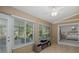 Bright sunroom with tile floors, ceiling fan, and sliding glass doors to the bedroom and outdoor patio at 1105 Flora Vista St, New Port Richey, FL 34655