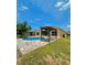 Backyard view featuring the pool and a pergola at 11055 Belle Haven Dr, New Port Richey, FL 34654