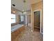 Bathroom features a tiled soaking tub, glassed-in shower, and an open doorway to the bedroom at 11055 Belle Haven Dr, New Port Richey, FL 34654