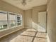 Bright bedroom featuring tiled floors, neutral paint, and a large window for natural light at 11055 Belle Haven Dr, New Port Richey, FL 34654