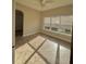 Bright bedroom featuring tiled floors, neutral paint, and a large window for natural light at 11055 Belle Haven Dr, New Port Richey, FL 34654