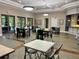 Inviting dining area featuring multiple tables, chairs, and large windows offering plenty of natural light at 11055 Belle Haven Dr, New Port Richey, FL 34654