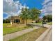 Single-story home with tan exterior, well-maintained lawn, and paved driveway at 11055 Belle Haven Dr, New Port Richey, FL 34654