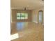 Bright living room boasting tile flooring and a large window overlooking the pool area at 11055 Belle Haven Dr, New Port Richey, FL 34654
