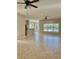 Living area with breakfast bar, pool view, and ceiling fans at 11055 Belle Haven Dr, New Port Richey, FL 34654
