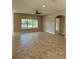 Spacious living room featuring tile flooring and a scenic pool view, great for relaxing at 11055 Belle Haven Dr, New Port Richey, FL 34654
