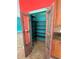 Walk-in pantry with custom distressed doors and metal shelving at 11055 Belle Haven Dr, New Port Richey, FL 34654
