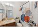 Bathroom featuring a toilet, vanity with sink, decorative shower curtain, and a washing machine at 1108 Blackwater Dr, Wesley Chapel, FL 33543