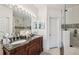 Elegant bathroom with double sinks, granite countertops, and a luxurious, glass-enclosed shower at 1108 Blackwater Dr, Wesley Chapel, FL 33543