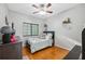 This bedroom has a bed, dresser, and wood floors, creating a comfy and stylish retreat at 1108 Blackwater Dr, Wesley Chapel, FL 33543