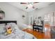 Bedroom featuring wood floors, ceiling fan, decor, vanity, window, and bed at 1108 Blackwater Dr, Wesley Chapel, FL 33543
