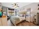 Comfortable bedroom featuring a ceiling fan, natural light, and hardwood floors at 1108 Blackwater Dr, Wesley Chapel, FL 33543
