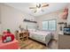 Charming bedroom featuring a ceiling fan, wood floors, window, and playful decor at 1108 Blackwater Dr, Wesley Chapel, FL 33543