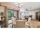 Dining area with glass table, access to patio, and views to a cozy living space at 1108 Blackwater Dr, Wesley Chapel, FL 33543