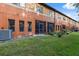 Exterior of a multi-unit property with green lawn, and a glimpse of nature beyond at 1108 Blackwater Dr, Wesley Chapel, FL 33543