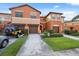Townhome featuring multi-toned paint, garages, landscaping, and a welcoming entrance at 1108 Blackwater Dr, Wesley Chapel, FL 33543