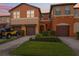 Inviting townhome featuring an attached garage, landscaped yard, and a warm, colorful exterior at 1108 Blackwater Dr, Wesley Chapel, FL 33543