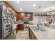 Spacious kitchen featuring stainless steel appliances, wood cabinets, and a sizable island at 1108 Blackwater Dr, Wesley Chapel, FL 33543