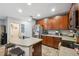 Large kitchen with stainless appliances, wood cabinetry, and a breakfast bar at 1108 Blackwater Dr, Wesley Chapel, FL 33543