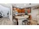 Bright kitchen featuring wood cabinets, an island, and barstool seating at 1108 Blackwater Dr, Wesley Chapel, FL 33543